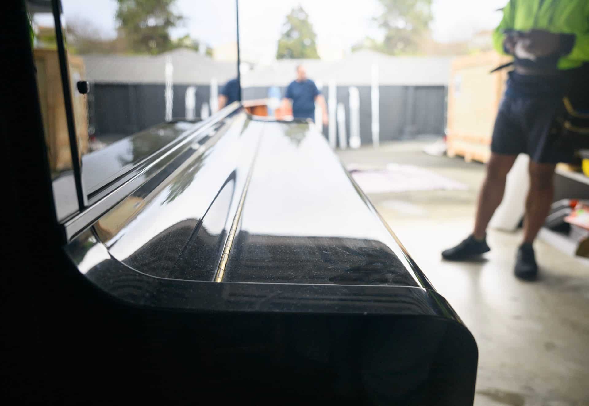 Unrecognizable workers preparing to move a piano. Concept of home moving and delivery.